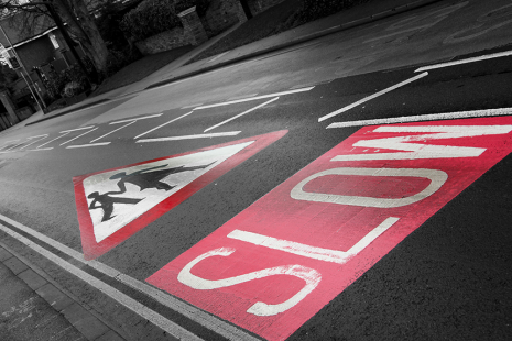 Slow down road sign